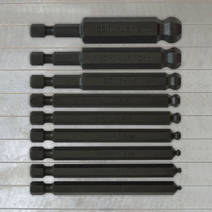 Set of black drill bits with visible branding on a metallic surface