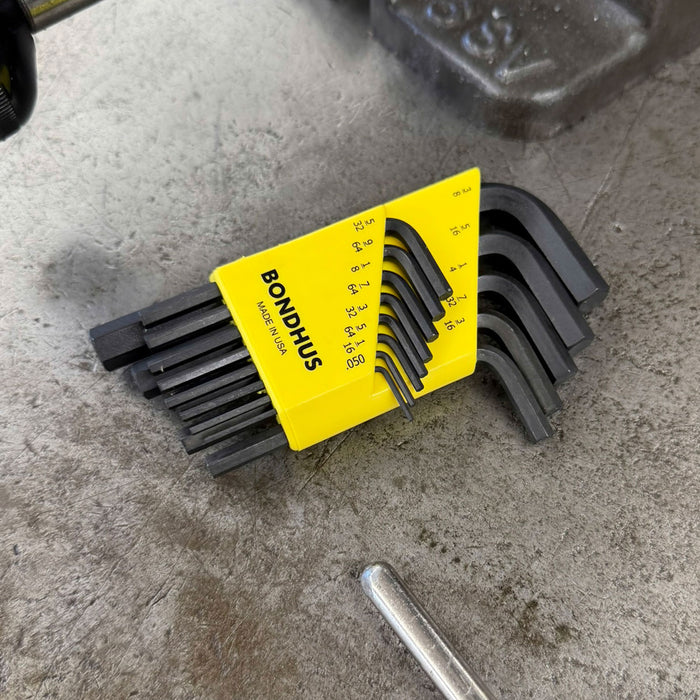 Set of hex keys with a yellow Bondhus tool case on a concrete surface