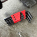 Set of black hex keys with red holder on a concrete surface