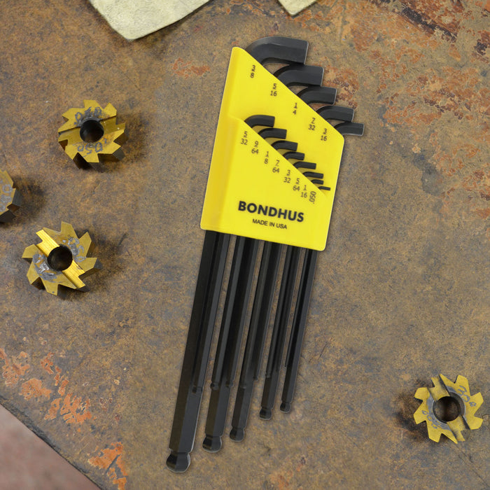 Set of 13 black L wrenches in a yellow Bondhus case on a rusty metal surface