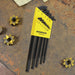 Set of 13 black L wrenches in a yellow Bondhus case on a rusty metal surface