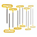 A set of cusion grip T-handle hex keys with yellow grips and black shafts in various sizes, laid out parallel to each other.