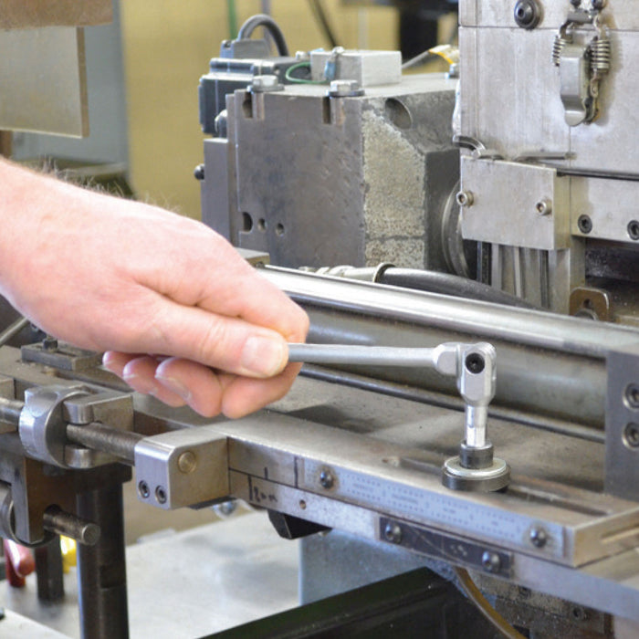Person operating a machine with a tool in a workshop setting