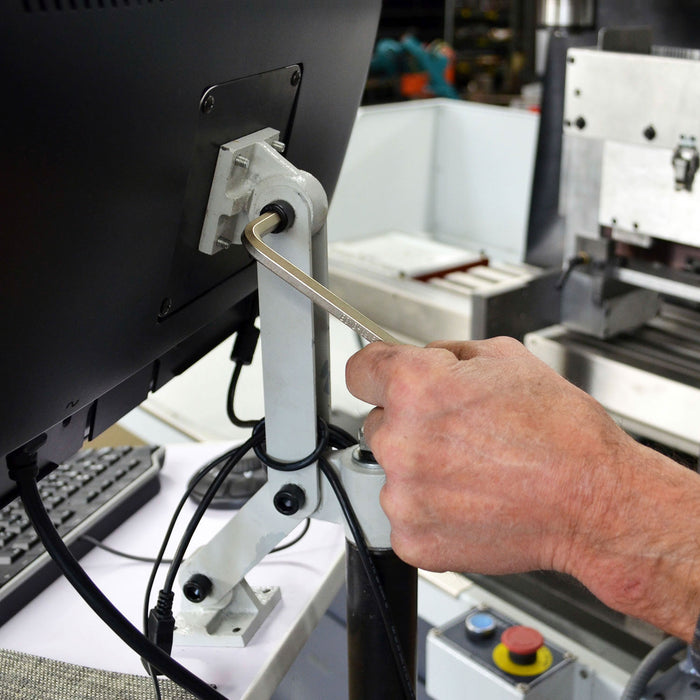 Silver Hex Ky being used to tighten the fixing on the back of a computer monitor
