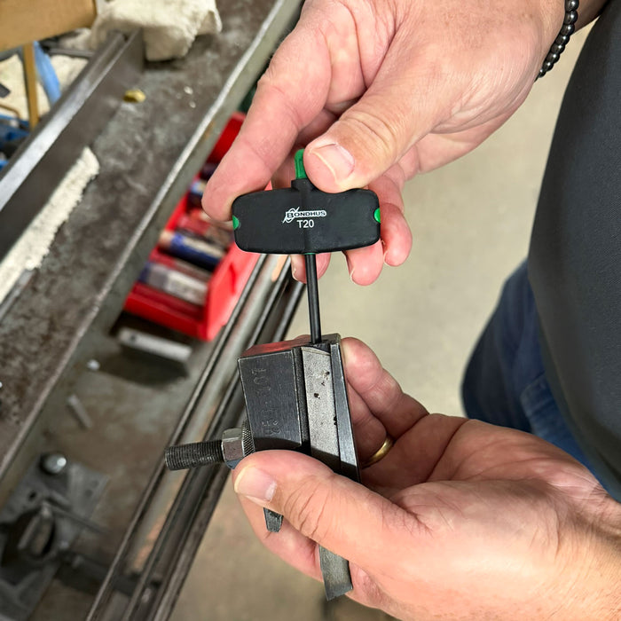 Person holding a Torx Wing Tool with a tool chest in the background