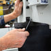 Person using a tool on a machine in a workshop setting