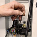 Hand adjusting a pressure gauge on a mechanical setup