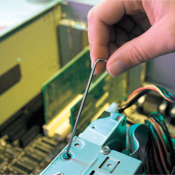 Hand using a hex key on a electronic component with a blurred background k
