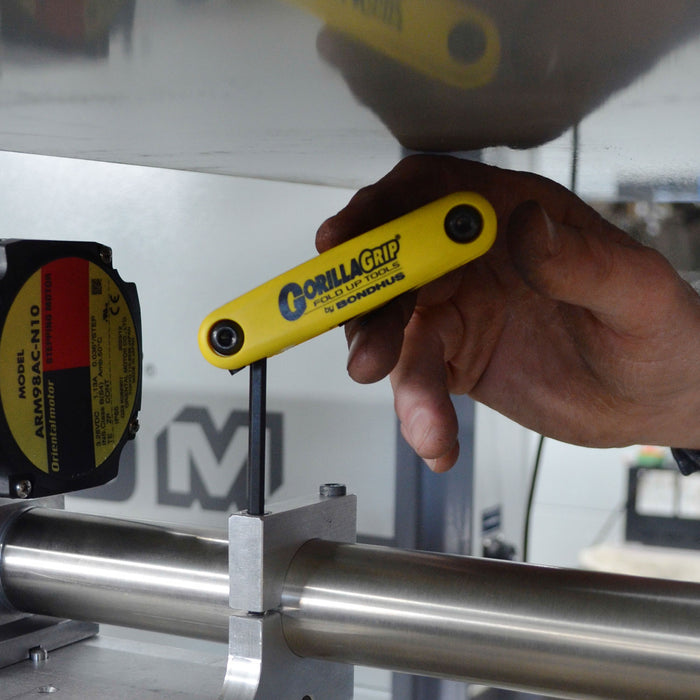 Hand using a Gorilla Grip tool on a metal bar with a blurred background